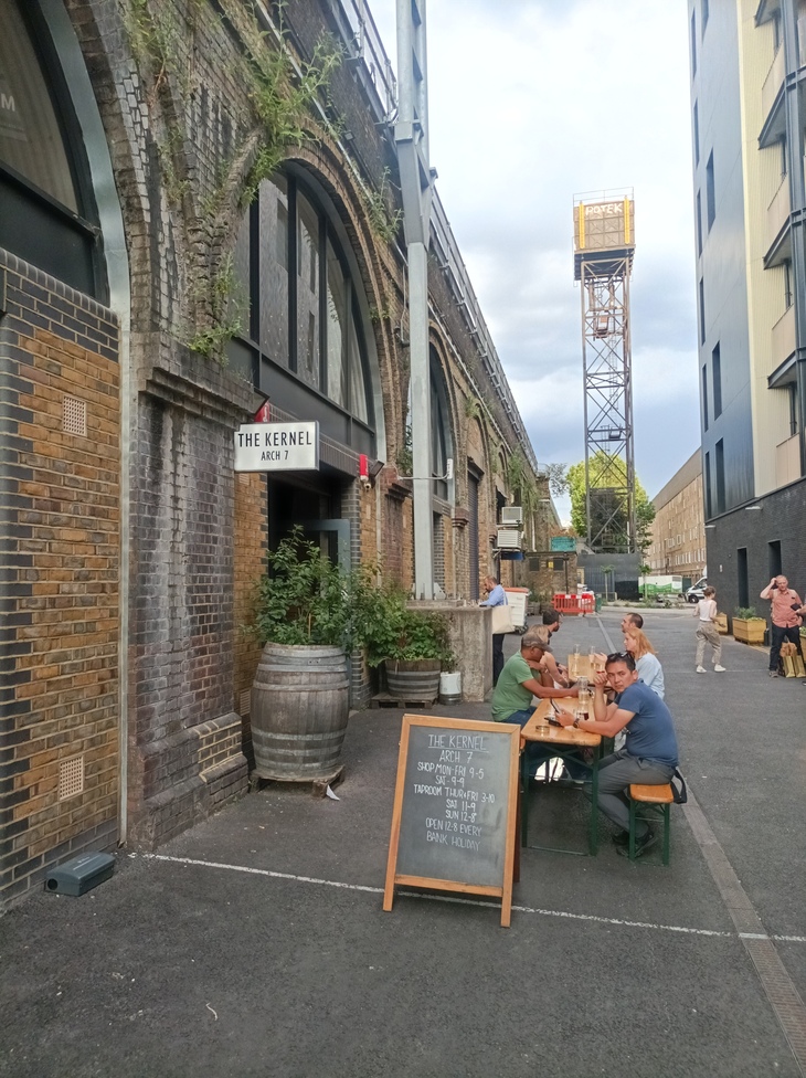 Best taprooms in London: People sitting outside a taproom beneath brick railway arches