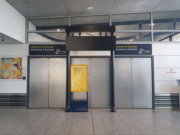 Two large metal doors are firmly closed next to each other. The eurostar signs are seen above the door.