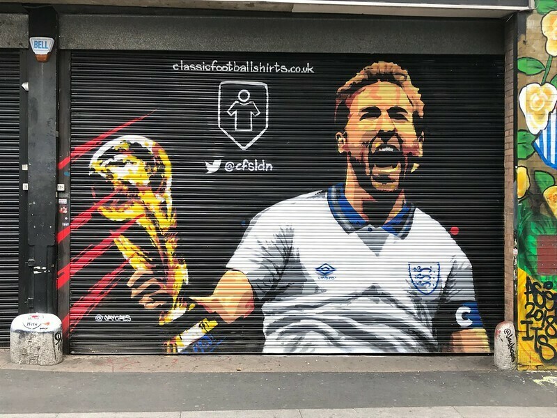 Harry Kane holding the world cup, painted on a shutter and not in real life sadly