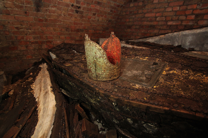 A bishops's mitre on an old lead coffin