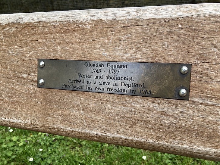 A bench plaque noting the life of Equiano