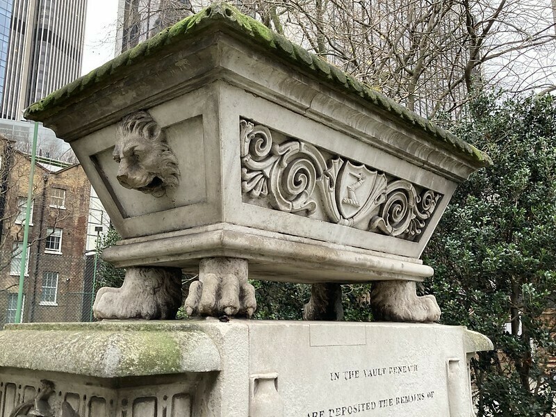A tomb with a lion's head and paws. very odd