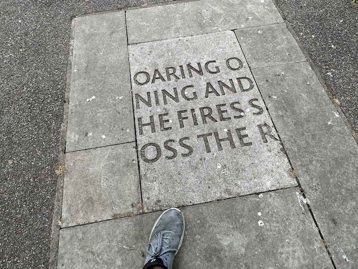 A trainer steps on a flagstone inscribed with cryptic writing