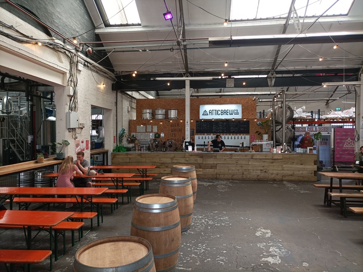 Things to do in Birmingham: A large taproom with wooden benches
