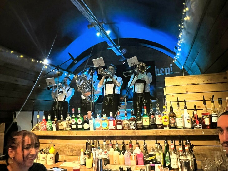 London Oktoberfest  2023: An oompah bands plays in the background, behind a bar