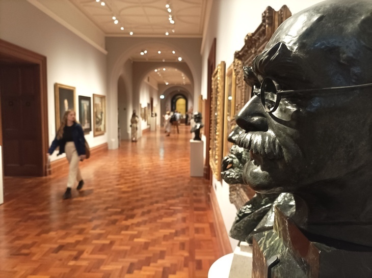 Looking down a corridor in the National Portrait Gallery, with a series of busts on the right wall