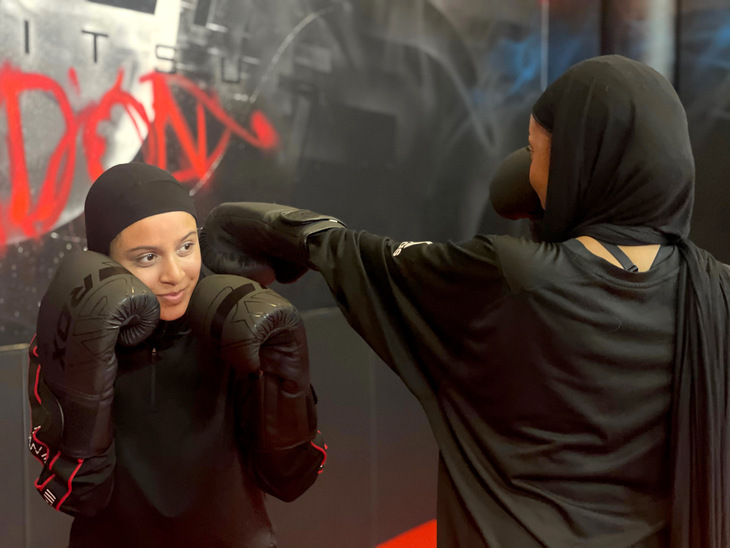 Two women in hijabs sparring