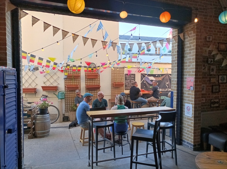 London Oktoberfest  2023: People drink outside beneath bunting