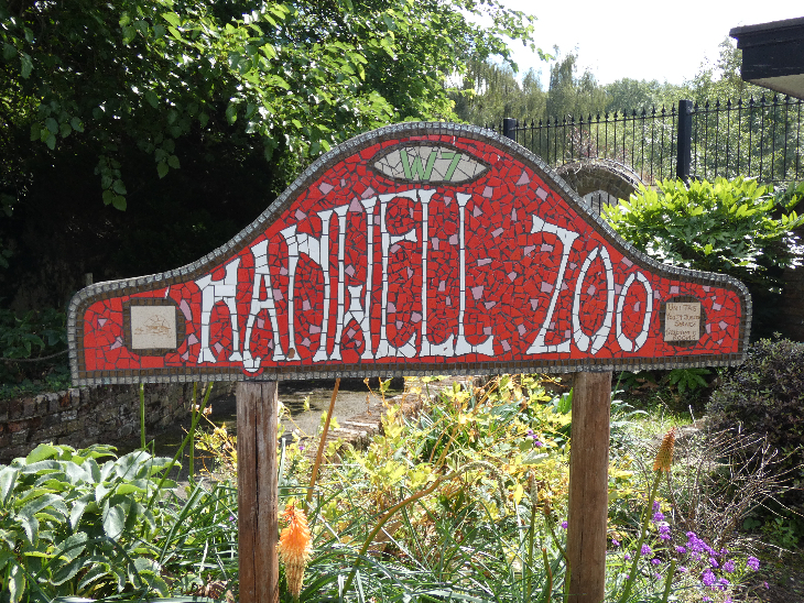 A freestanding 'Hanwell Zoo' sign made from red and white mosaics.
