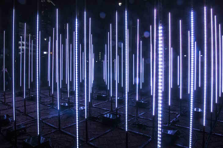 A group of vertical white glowing lines, laid out in a grid pattern