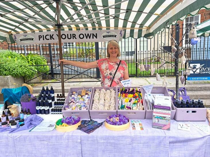 A woman mans a stall selling lavender themed goodies