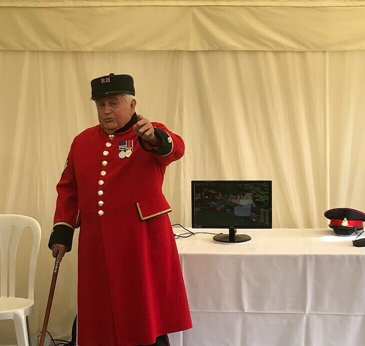 A chelsea pensioner pointing at camera