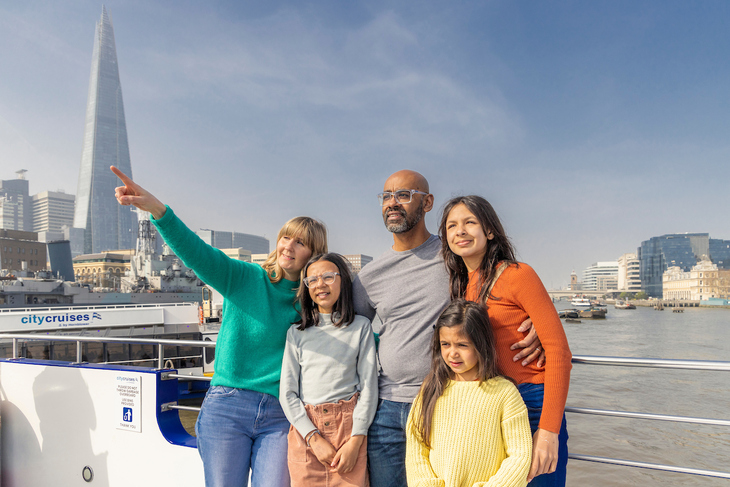 A sightseeing family on a boat - the Shard behind them