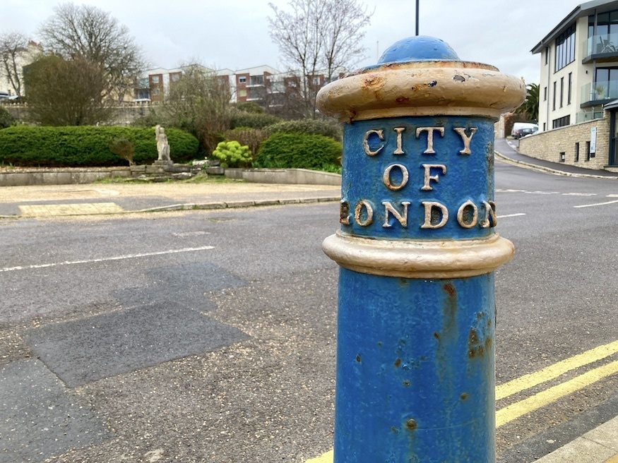 A blue city of london bollard in swanage