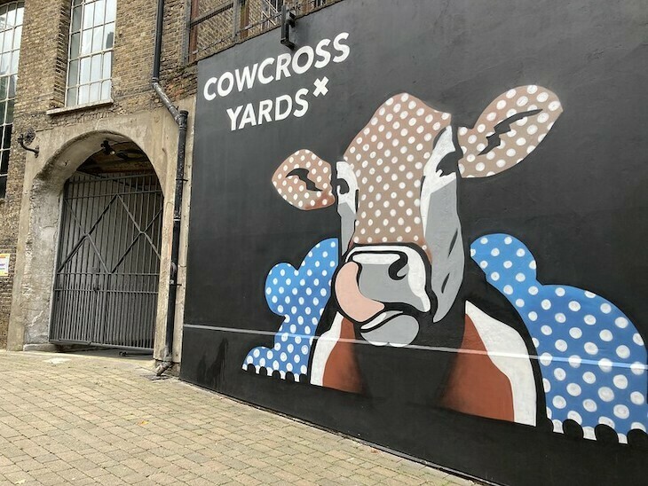 Cowcross Yards in Farringdon with a street art cow licking its lips