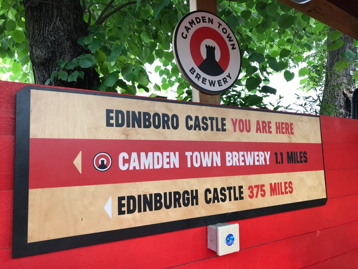 A sign pointing out the Edinboro Castle pub is 375 miles from the actual Edinburgh Castle