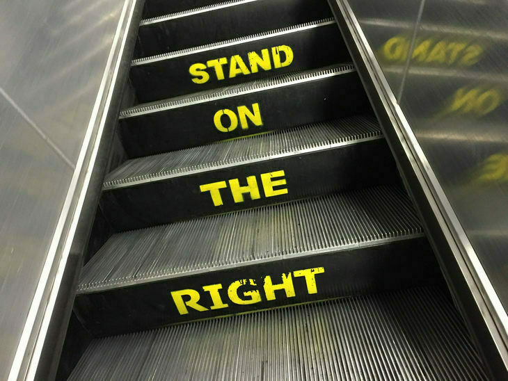 An escalator with 'stand on the right' written all over it