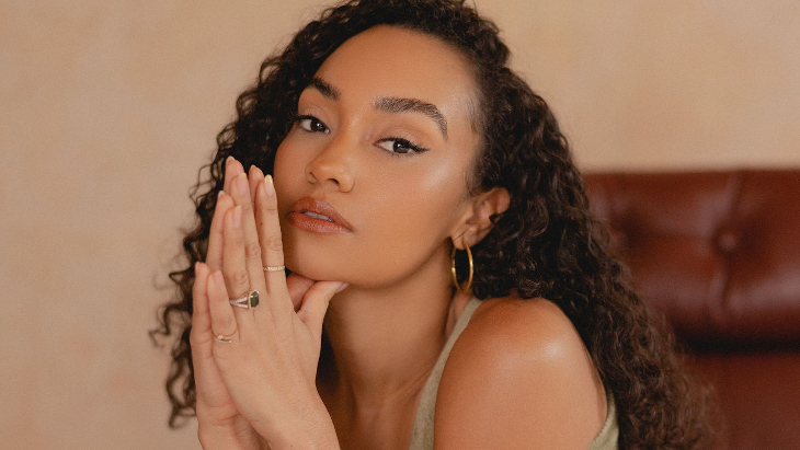 Autumn in London: Leigh-Anne Pinnock, looking straight at the camera with her hands together in front of her face.