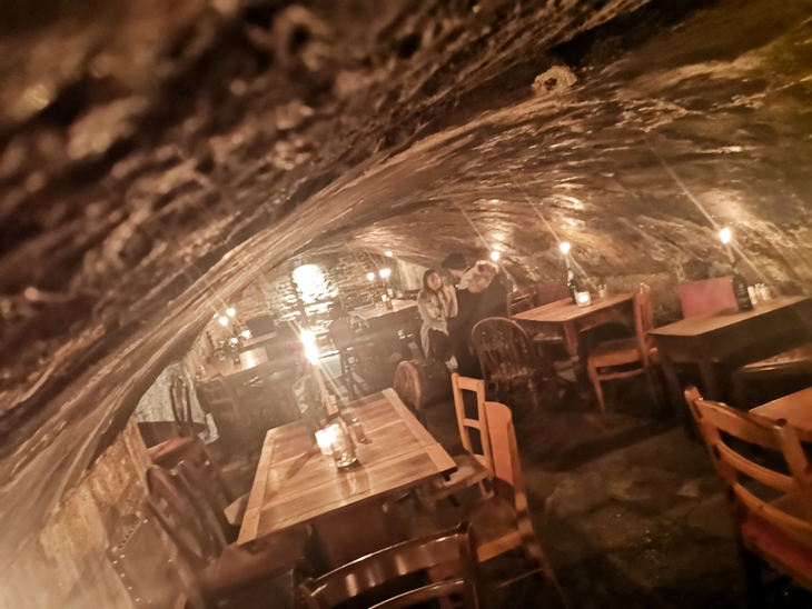 The inside of Gordon's Wine Bar is a cave-like space with candlelit tables