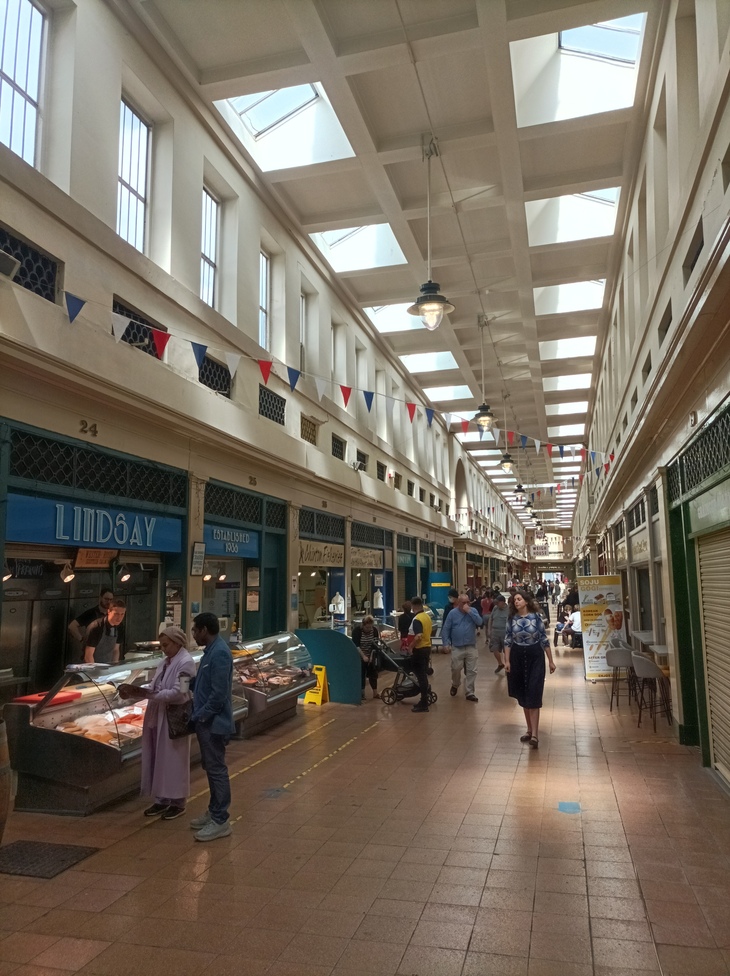 An indoor market with skylights in the ceiling