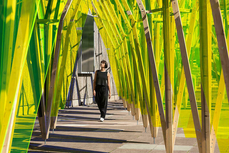 Woman walking through a yellow tunnel