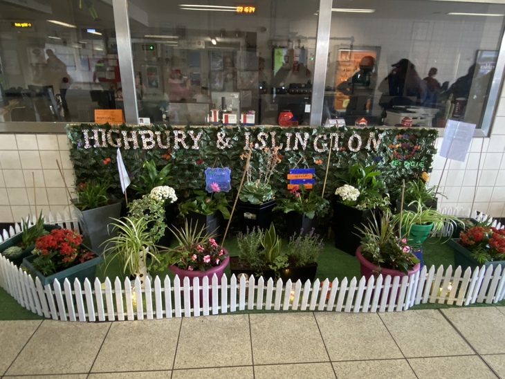 A tiny garden outside a ticket office with 'Highbury and Islington' written on it