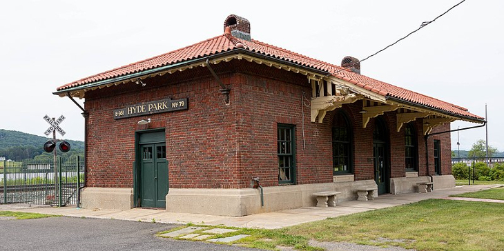 A rectangular, one-story redbrick building, formerly a railway station.