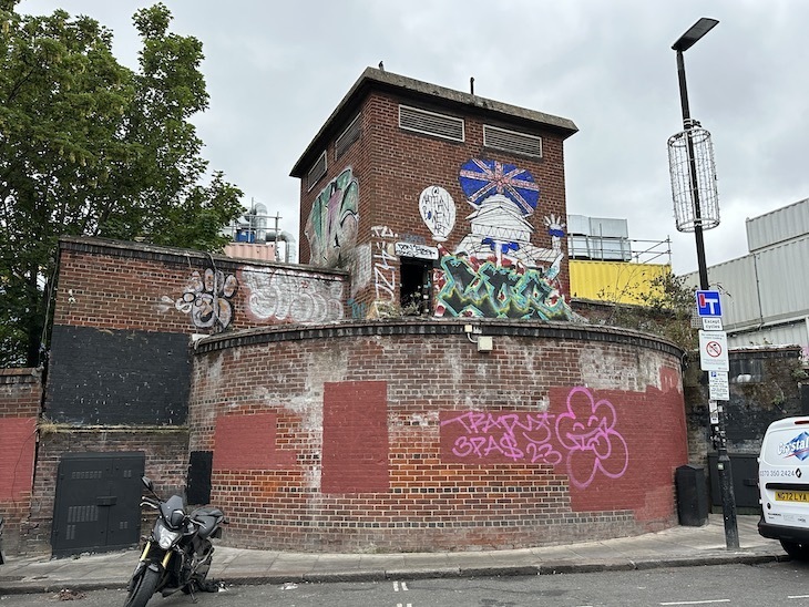 A graffiti spattered brick building with a drum-shaped front - a former deep level shelter