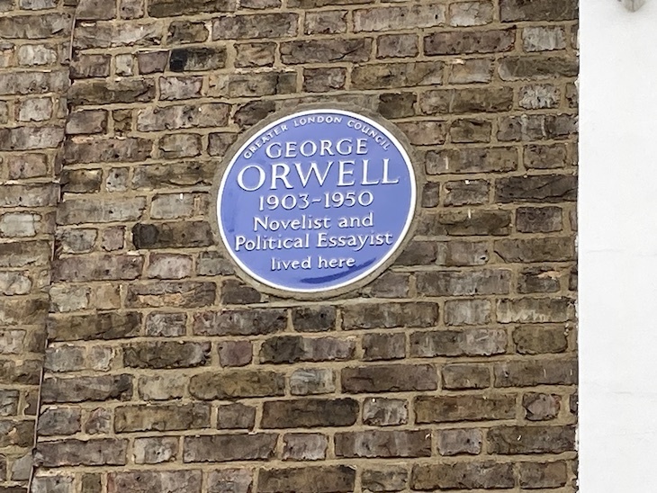 George Orwell blue plaque on a brown brick wall