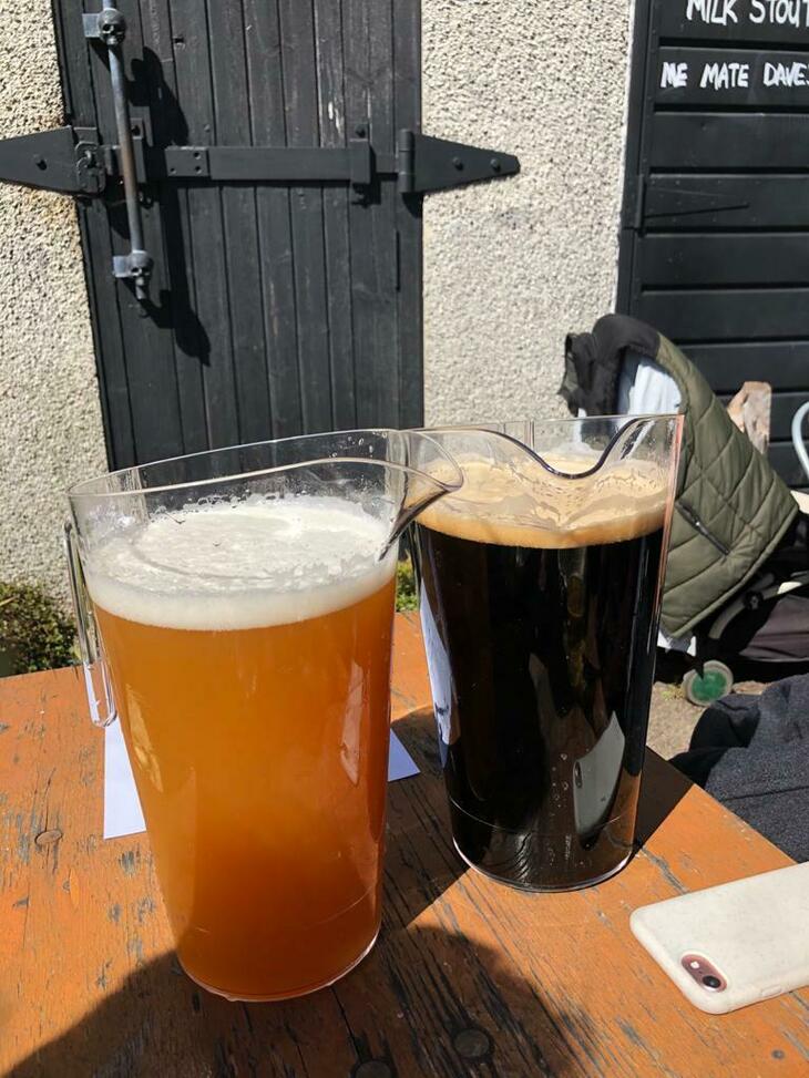 Brewery taprooms in London: Two pitchers of beer - one hazy, one black