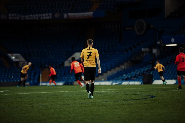 Josh in his yellow kit, walking away from the camera