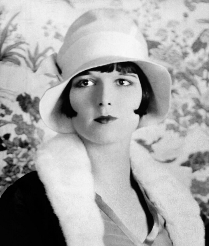 A handsome woman in 1920s hat and furs