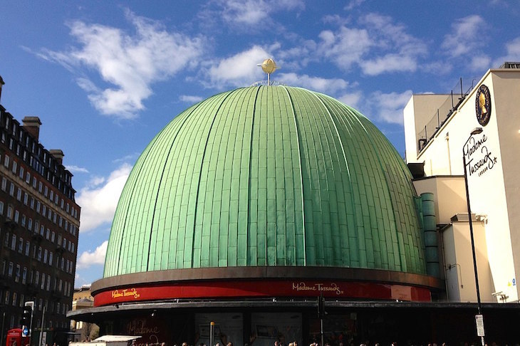 The green dome of the former Planetarium, now Madame Tussauds, on Baker Street. It now has red 'Madame Tussauds' branded signs around the bottom.