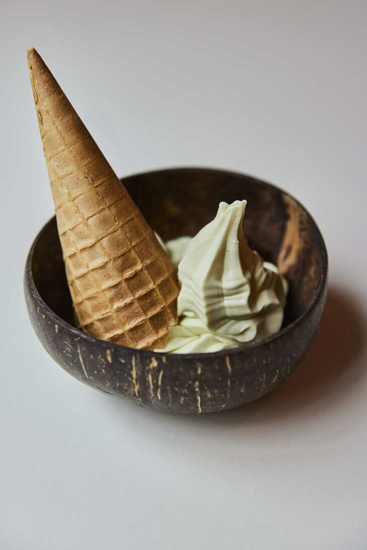 An upside down ice cream cornet in a bowl