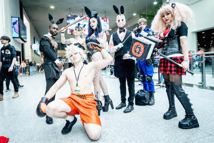 People dressed as an assortment of characters pose for a group photo