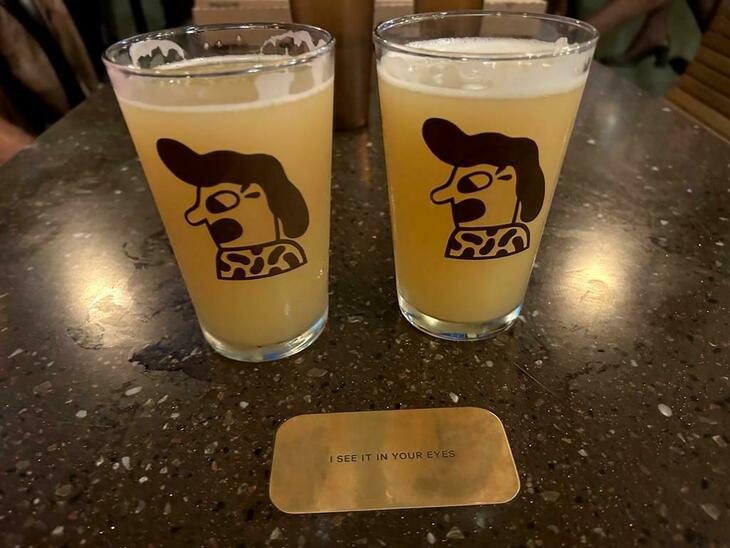 Brewery taprooms in London: Two glasses of hazy beer with a Rick Roll plaque in front of them