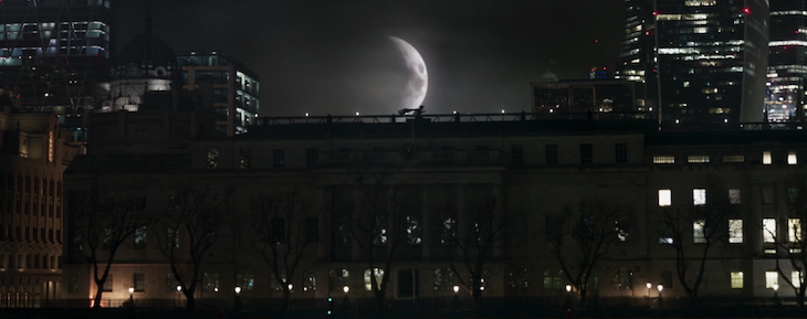 Moon Knight runs across a rooftop with the moon in the background