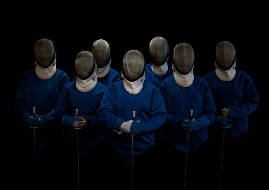 A group of fencers, all with their visors down