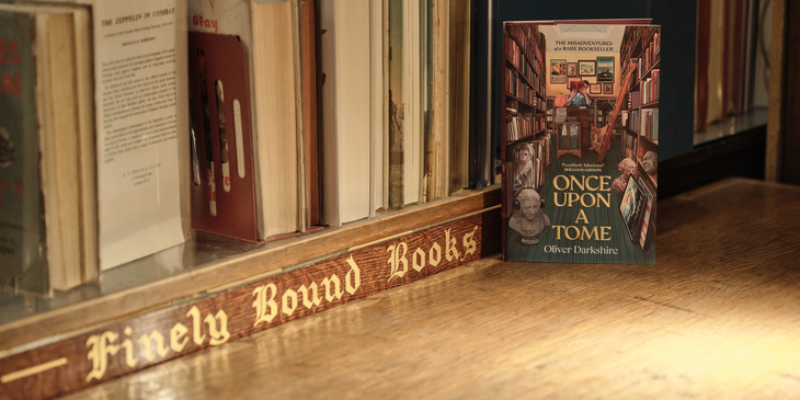 Oliver's book on display next to a row of antique books and in gold lettering: 