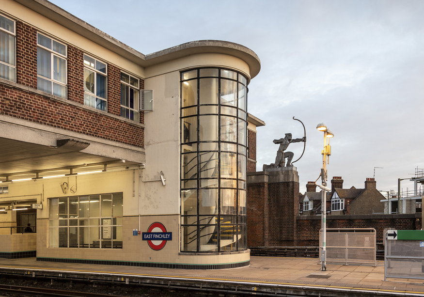 The curvaceous form of East Finchley station, with the silhouette of the art deco archer visible