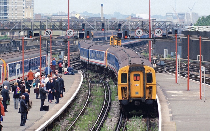Old British Rail trains pull in as commuters wait