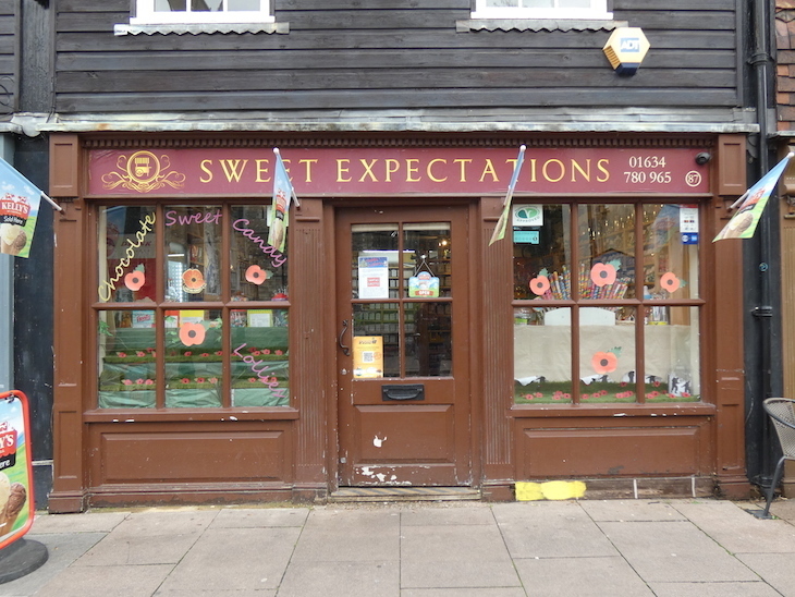 Exterior of Sweet Expectations sweet shop, with flags advertising ice cream hanging from the building