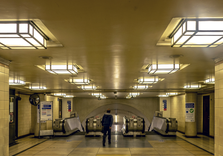 Walk towards the top of escalators lined with glorious art deco style ceiling lights