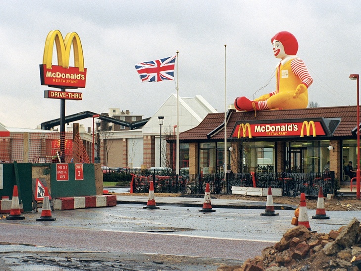 A McDonald's with a huge Ronald McDonalds sat on top