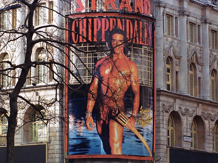 An ad for the Chippendales, with a big greased up torso on it