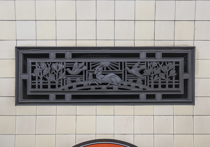 A beautiful art deco vent with scenes of nature on it