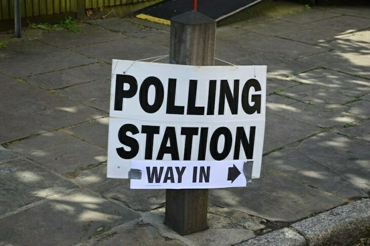 A polling station sign showing the way in