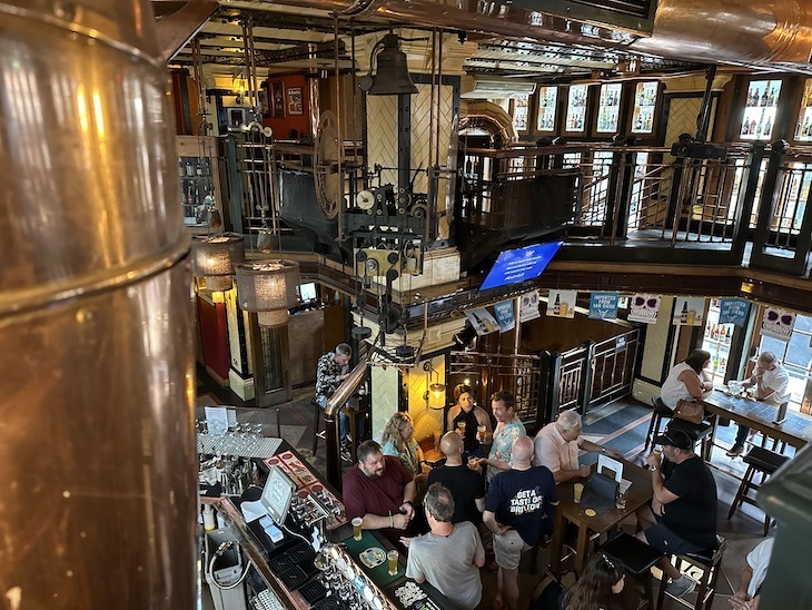 The inside of the Porterhouse in Covent Garden, with lots of brass and wood