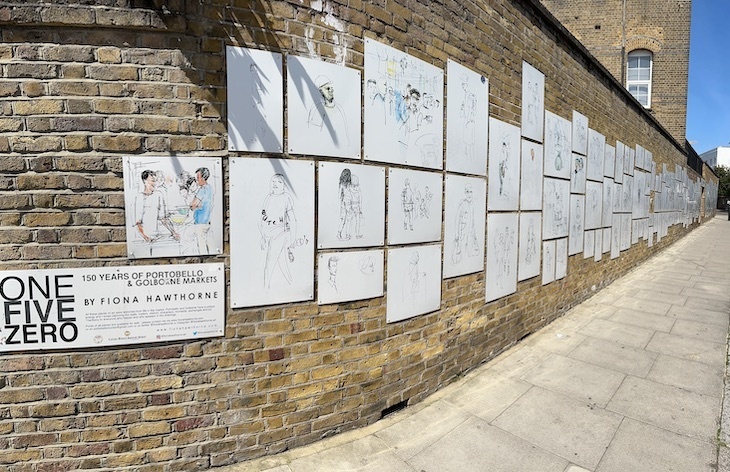 A panorama shot showing works of illustration stretching along a wall