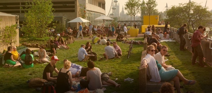 Best rooftop bars London: people sitting on a grassy rooftop bar